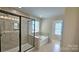 Bathroom with a glass door shower and a soaking tub near a window at 11521 Allen A Brown Rd, Charlotte, NC 28269