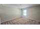 Neutral bedroom with carpet and a window allowing ample natural light at 11521 Allen A Brown Rd, Charlotte, NC 28269