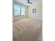 Bedroom with two windows, carpet, ceiling fan, and a mirror on the wall at 11521 Allen A Brown Rd, Charlotte, NC 28269