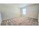 Bright bedroom featuring neutral walls and carpet with a window letting in natural light at 11521 Allen A Brown Rd, Charlotte, NC 28269