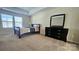 Bedroom featuring two windows, carpet, and a dresser with mirror at 11521 Allen A Brown Rd, Charlotte, NC 28269