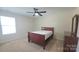 Bedroom featuring one window, carpet, ceiling fan, and dresser with mirror at 11521 Allen A Brown Rd, Charlotte, NC 28269