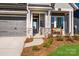 Inviting front porch with stone details and a welcoming bench at 1314 Idyllic Ln, Waxhaw, NC 28173