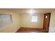 Bright bedroom with wood floors and window at 12608 Rocky River Church Rd, Charlotte, NC 28215