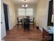 Dining room with laminate flooring and a four-person dining table set at 12608 Rocky River Church Rd, Charlotte, NC 28215