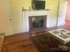 Living room with fireplace and wood floors at 12608 Rocky River Church Rd, Charlotte, NC 28215