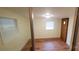 Room with laminate flooring, window with blinds, and exterior door at 12608 Rocky River Church Rd, Charlotte, NC 28215