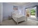 Charming bedroom with white furniture, light blue walls and a window showcasing the outdoor view at 167 Maple View Dr, Troutman, NC 28166