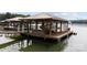 View of boat dock and boat, resting on the lift inside the covered structure at 167 Maple View Dr, Troutman, NC 28166