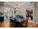 Elegant dining room with large windows, modern chandelier, and seamless access to the well-appointed kitchen at 167 Maple View Dr, Troutman, NC 28166