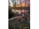 Enjoy sunsets over the lake from the stone firepit with built-in seating at 167 Maple View Dr, Troutman, NC 28166