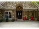 Stunning stone facade and custom double doors create a grand entrance to the home at 167 Maple View Dr, Troutman, NC 28166