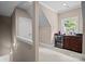 Hallway view with wet bar including a wine cooler, countertop space, and a window with a view at 167 Maple View Dr, Troutman, NC 28166