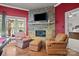 Cozy living room featuring a stone fireplace, chairs, and a pool table in the corner at 167 Maple View Dr, Troutman, NC 28166