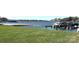 Beautiful waterfront property with lush green grass, gentle sloping bank, and numerous boat slips at 18726 Nautical Dr # 303, Cornelius, NC 28031