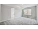 Simple bedroom with grey carpet, a window, and access to another room at 5027 Mclaughlin Loop # 61, Waxhaw, NC 28173