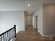 Upstairs hallway with light walls and wood-look floors at 5027 Mclaughlin Loop # 61, Waxhaw, NC 28173