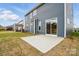 A patio extends from a modern home with sliding glass doors, offering a seamless indoor-outdoor living experience at 8736 Acadia Pkwy # 601, Sherrills Ford, NC 28673