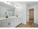 Modern bathroom with dual sinks, white cabinets and wood look flooring at 8736 Acadia Pkwy # 601, Sherrills Ford, NC 28673