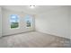 Bedroom with two windows with exterior view and neutral carpet at 8736 Acadia Pkwy # 601, Sherrills Ford, NC 28673