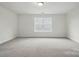 A spacious bedroom features plush carpeting and a sunlit window, creating a serene and inviting atmosphere at 8736 Acadia Pkwy # 601, Sherrills Ford, NC 28673