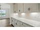 Kitchen featuring white cabinets and countertops, mosaic backsplash, and stainless steel appliances at 8736 Acadia Pkwy # 601, Sherrills Ford, NC 28673