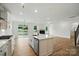 Open kitchen and living area with a fireplace, large island, and stainless steel appliances at 8736 Acadia Pkwy # 601, Sherrills Ford, NC 28673