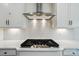 Modern kitchen featuring stainless steel range hood and white backsplash at 8736 Acadia Pkwy # 601, Sherrills Ford, NC 28673