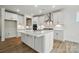 Modern kitchen with white cabinets, stainless steel appliances, and a large island at 8736 Acadia Pkwy # 601, Sherrills Ford, NC 28673