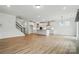 Open floor plan with a kitchen, living room, and staircase with wood floors at 8736 Acadia Pkwy # 601, Sherrills Ford, NC 28673