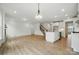 Open-concept living area with a kitchen island, staircase, and modern lighting at 8736 Acadia Pkwy # 601, Sherrills Ford, NC 28673