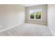 Empty bedroom with a double window overlooking trees and a carpeted floor at 16004 Deer River Rd, Charlotte, NC 28278