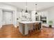Bright kitchen features stainless steel appliances, an island with bar seating, and stylish pendant lighting at 16004 Deer River Rd, Charlotte, NC 28278
