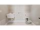 Functional laundry room features utility sink, tile flooring, and hookups for a washer and dryer at 16004 Deer River Rd, Charlotte, NC 28278