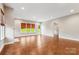 Well-lit living room featuring hardwood floors, neutral walls, and a view of the outdoors at 16004 Deer River Rd, Charlotte, NC 28278
