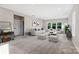Bright and airy living room featuring plush seating, a patterned rug, and large windows at 16004 Deer River Rd, Charlotte, NC 28278