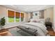 Main bedroom with seating, hardwood flooring, and large bright windows at 16004 Deer River Rd, Charlotte, NC 28278