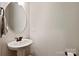Small, classic powder room with pedestal sink and bronze hardware at 16004 Deer River Rd, Charlotte, NC 28278