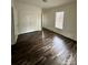 Bedroom with wood-look flooring, closet, and window at 360 Spring Sw St, Concord, NC 28025