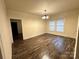 Spacious living room with hardwood floors, modern lighting, and neutral walls at 360 Spring Sw St, Concord, NC 28025