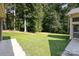 Well-maintained backyard with lush green grass and mature trees at 5888 Hidden Oaks Ln, Clover, SC 29710