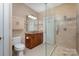 Bathroom with vanity, granite countertops, and glass shower with tile details at 5888 Hidden Oaks Ln, Clover, SC 29710