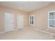 Bright bedroom with two windows and neutral walls at 5888 Hidden Oaks Ln, Clover, SC 29710