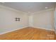 Empty bedroom with hardwood floors, a large window, and neutral walls at 5888 Hidden Oaks Ln, Clover, SC 29710