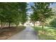 Long driveway leads to a charming home with well-manicured lawn and mature trees at 5888 Hidden Oaks Ln, Clover, SC 29710