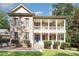 Charming brick home with a welcoming double-decker front porch and manicured landscaping at 5888 Hidden Oaks Ln, Clover, SC 29710