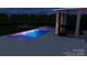 Modern pool features unique lighting, pool house, and outdoor entertaining space at 5888 Hidden Oaks Ln, Clover, SC 29710