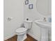 Simple bathroom with pedestal sink, toilet and wood floor at 181 Atwater Landing Dr, Mooresville, NC 28117