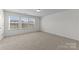 Well-lit bedroom featuring neutral walls and a large window at 181 Atwater Landing Dr, Mooresville, NC 28117