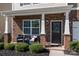 Inviting front porch with stone facade and charming decor at 181 Atwater Landing Dr, Mooresville, NC 28117